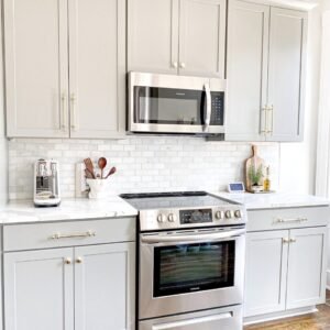 white microwave oven on white wooden cabinet